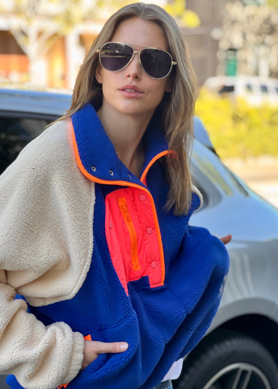 Hammill & Co super comfy and cozy new Alpes panelled polar fleece  with half button front in denim blue with raglan sleeves in a warm natural colour. Featuring contrast coloured front panel and orange coloured piping down the front. 