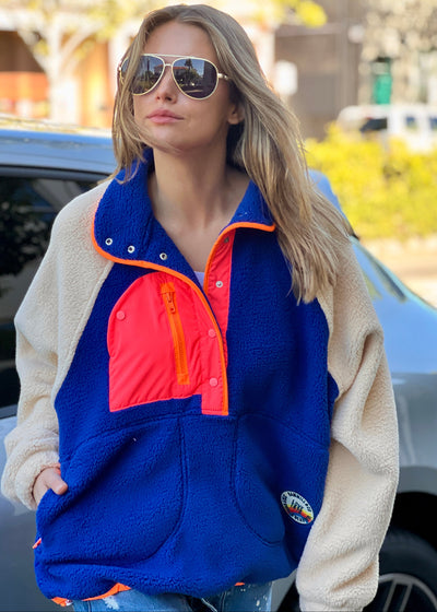 Hammill & Co super comfy and cozy new Alpes panelled polar fleece  with half button front in denim blue with raglan sleeves in a warm natural colour. Featuring contrast coloured front panel and orange coloured piping down the front. 