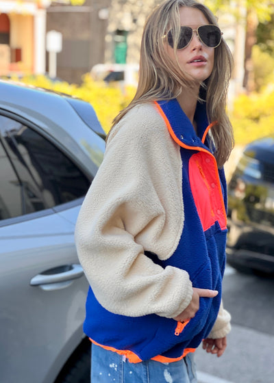 Hammill & Co super comfy and cozy new Alpes panelled polar fleece  with half button front in denim blue with raglan sleeves in a warm natural colour. Featuring contrast coloured front panel and orange coloured piping down the front. 