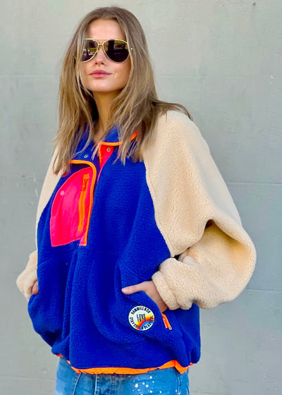 Hammill & Co super comfy and cozy new Alpes panelled polar fleece  with half button front in denim blue with raglan sleeves in a warm natural colour. Featuring contrast coloured front panel and orange coloured piping down the front. 