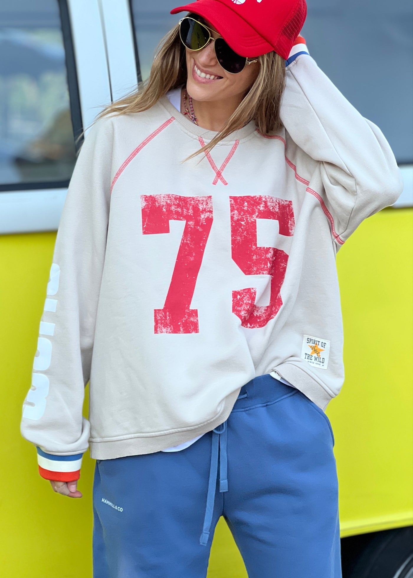 Hammill & Co New Sporty sweat is in a soft brushed fleece fabric in a washed natural colour with stripe rib cuffs. Distressed Red 75 print on the front and Word Series down each sleeve in washed white and Retro 1975 print across the back.