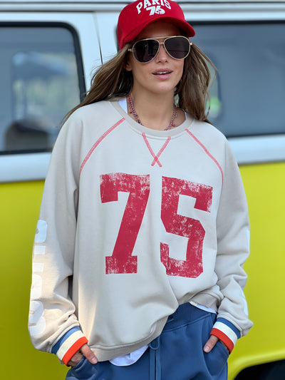 Hammill & Co New Sporty sweat is in a soft brushed fleece fabric in a washed natural colour with stripe rib cuffs. Distressed Red 75 print on the front and Word Series down each sleeve in washed white and Retro 1975 print across the back.