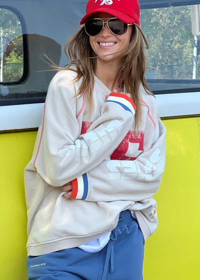 Hammill & Co New Sporty sweat is in a soft brushed fleece fabric in a washed natural colour with stripe rib cuffs. Distressed Red 75 print on the front and Word Series down each sleeve in washed white and Retro 1975 print across the back.