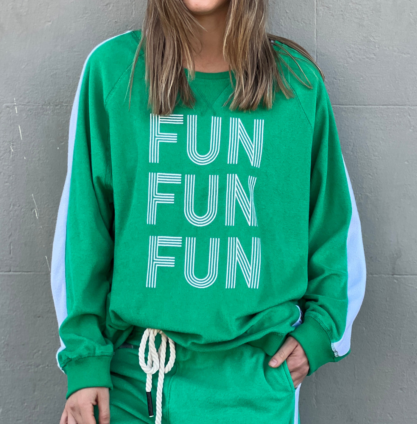 Hammill & Co lightweight, soft towelling sweat in green/white. Features our new Fun, Fun, Fun  print on the front, white panelled stripes down each sleeve, longer body length and rib waistband.