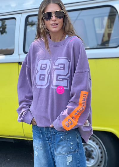 Hammill & Co  longer, slouchier style sweat  in our new garment washed fleece.  Washed white 82 print on the front and neon print down the left sleeve. Pops of hot pink and neon green! Happy vibes happy life embroidery at left side neck. 
Soft 100% Washed Cotton fleece. 