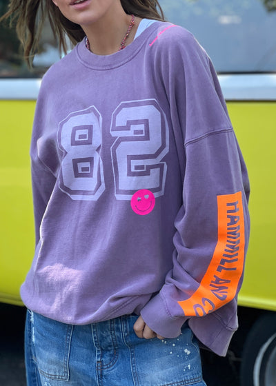 Hammill & Co  longer, slouchier style sweat  in our new garment washed fleece.  Washed white 82 print on the front and neon print down the left sleeve. Pops of hot pink and neon green! Happy vibes happy life embroidery at left side neck. 
Soft 100% Washed Cotton fleece. 