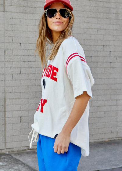 Hammill & Co tee with Rib panels on the sleeves and around the neck, peach cotton, La Vibe felt print on the front and small heart print on the back neck.