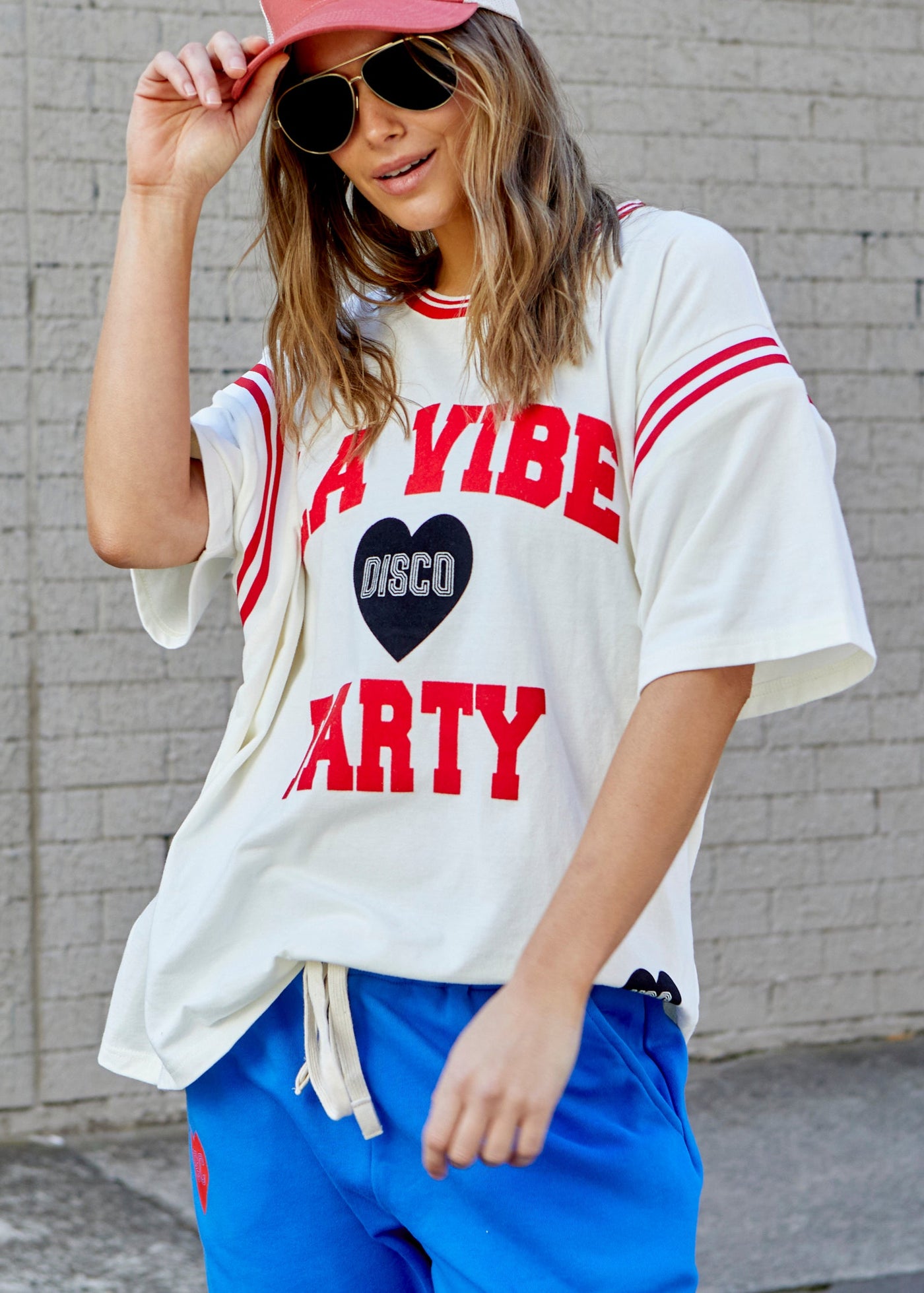 Hammill & Co tee with Rib panels on the sleeves and around the neck, peach cotton, La Vibe felt print on the front and small heart print on the back neck.