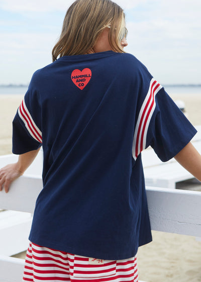 Hammill & Co New rib detail dark navy tee in our best selling slouchy fit. Features: Rib panels on the sleeves and around the neck, peach cotton, La Vibe felt print on the front and small heart print on the back neck.