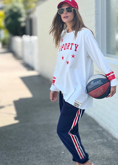 Hammill & Co oversized shape tee is here with raw hem.  Longer body and sleeves for a comfy look with leggings, distressed red sporty print on the front and stripes on each sleeve.