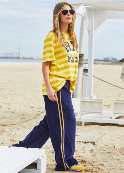 Hammill & Co Slouchy crew neck tee in a soft yellow and mustard stripe jersey with navy retro Mexico print on the front. Looks great worn back with the velour pants and shorts!