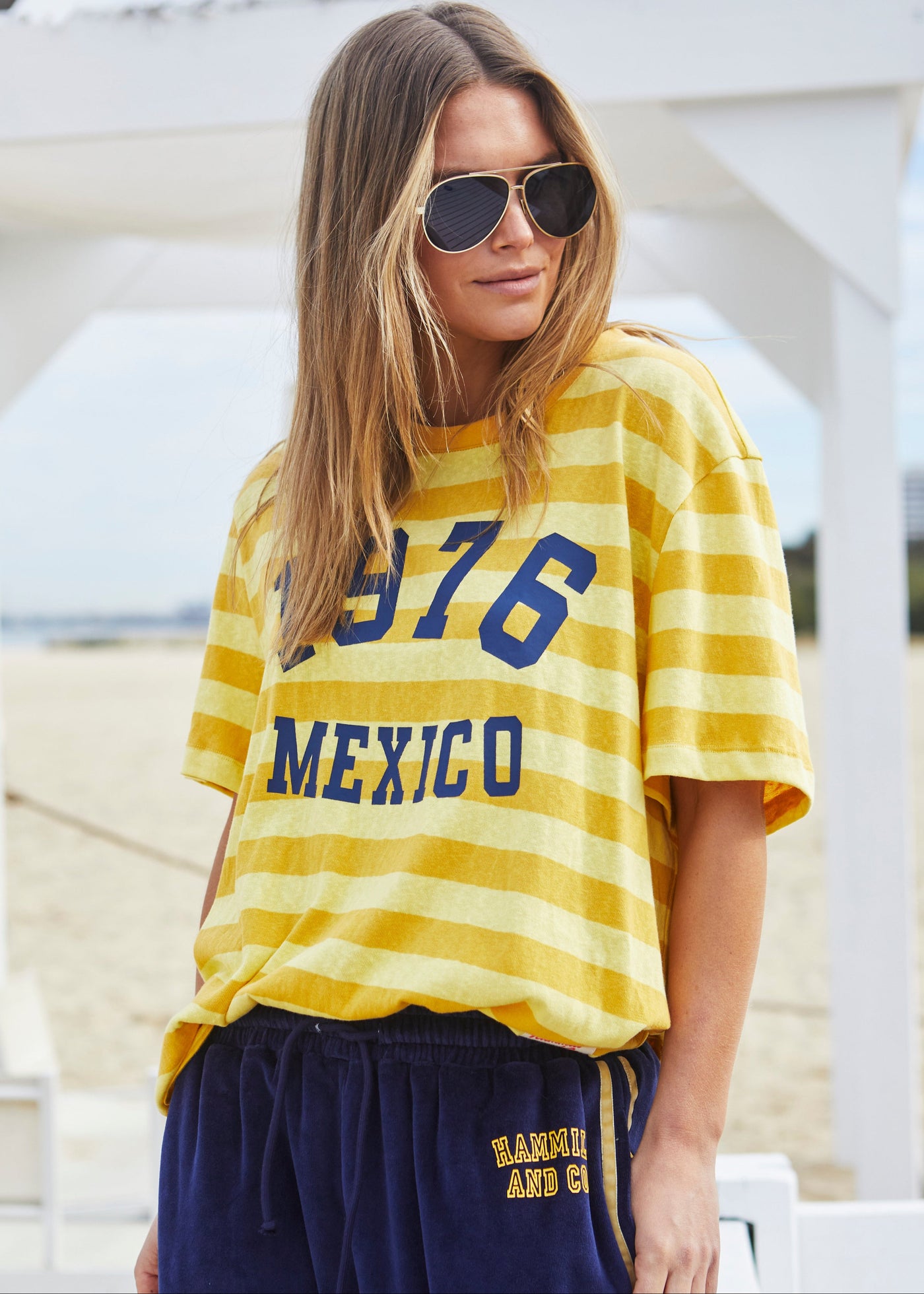 Hammill & Co Slouchy crew neck tee in a soft yellow and mustard stripe jersey with navy retro Mexico print on the front. Looks great worn back with the velour pants and shorts!