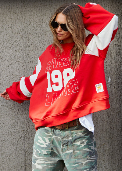 Hammill & Co Cannes 1988 red sweat panelled sweat with relaxed raglan sleeve and contrast panels with slight puff sleeve. The sweat is in a gorgeous washed red with natural panels and front chest print.