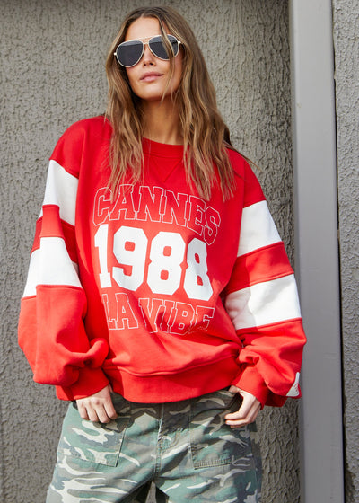 Hammill & Co Cannes 1988 red sweat panelled sweat with relaxed raglan sleeve and contrast panels with slight puff sleeve. The sweat is in a gorgeous washed red with natural panels and front chest print.