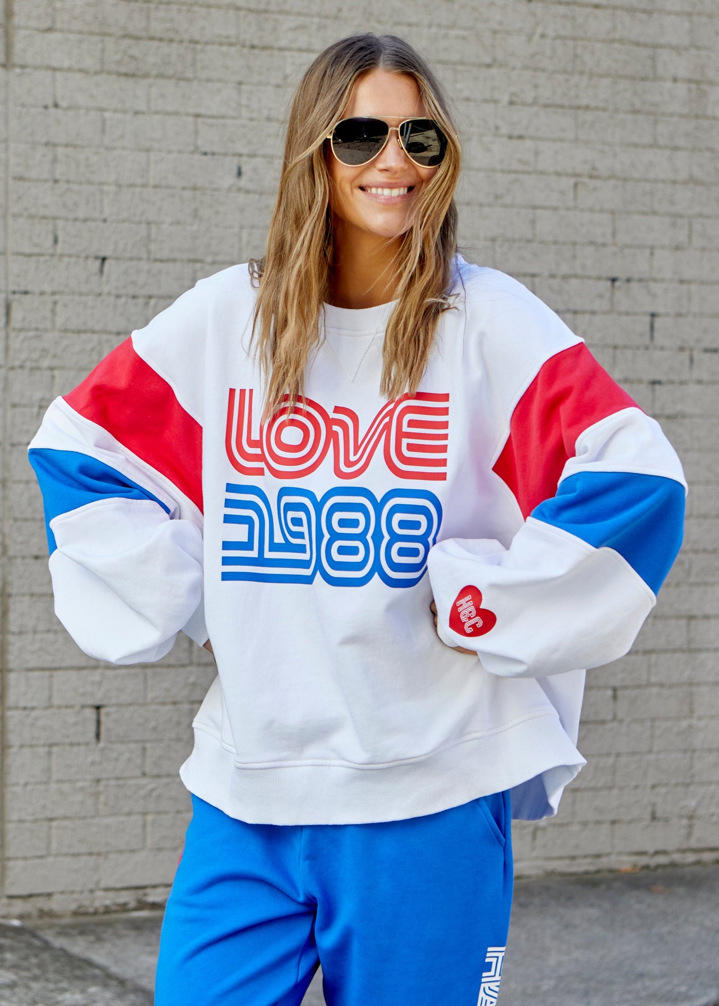 Hammill & Co LOVE 1988 white panelled sweat with relaxed raglan sleeve and contrast panels in blue and red with slight puff sleeve. 