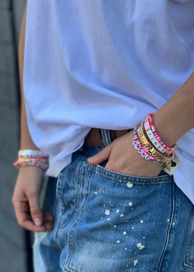 Hammill & Co Colourful set of 8 pink bracelets.  Features Vibes beaded bracelet, multi cube enamel bracelets,  Happy bracelet and mixed fine beaded ones.

