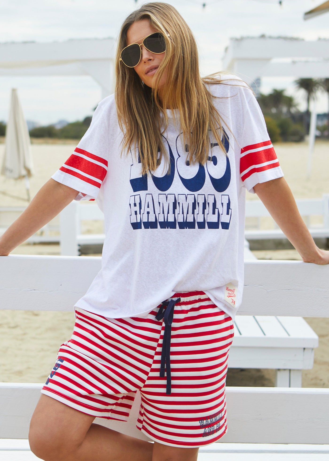 Hammill & Co White slouchy tee with navy 1985 print on the front and red stripes on each sleeve. Our standard over size fit, the same as our logo tees.