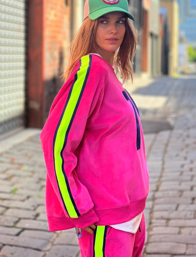 Hammill & Co slouchy sporty velour sweat in Hot pink with stripe tape down each sleeve and Sporty 75 chenille applique on the front.