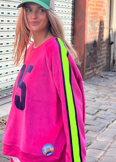 Hammill & Co slouchy sporty velour sweat in Hot pink with stripe tape down each sleeve and Sporty 75 chenille applique on the front.