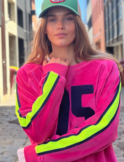 Hammill & Co slouchy sporty velour sweat in Hot pink with stripe tape down each sleeve and Sporty 75 chenille applique on the front.