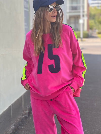 Hammill & Co slouchy sporty velour sweat in Hot pink with stripe tape down each sleeve and Sporty 75 chenille applique on the front.