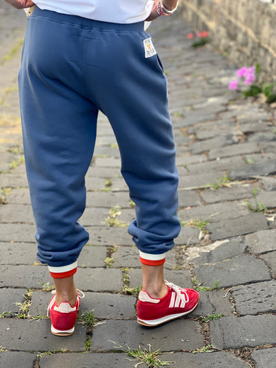 Hammill & Co Fleecy denim blue track pant with stripe cuffs, elastic waist band with draw cord, 7/8 length and small Hammill and Co logo on the right hip. Looks great worn back with the matching sweat.