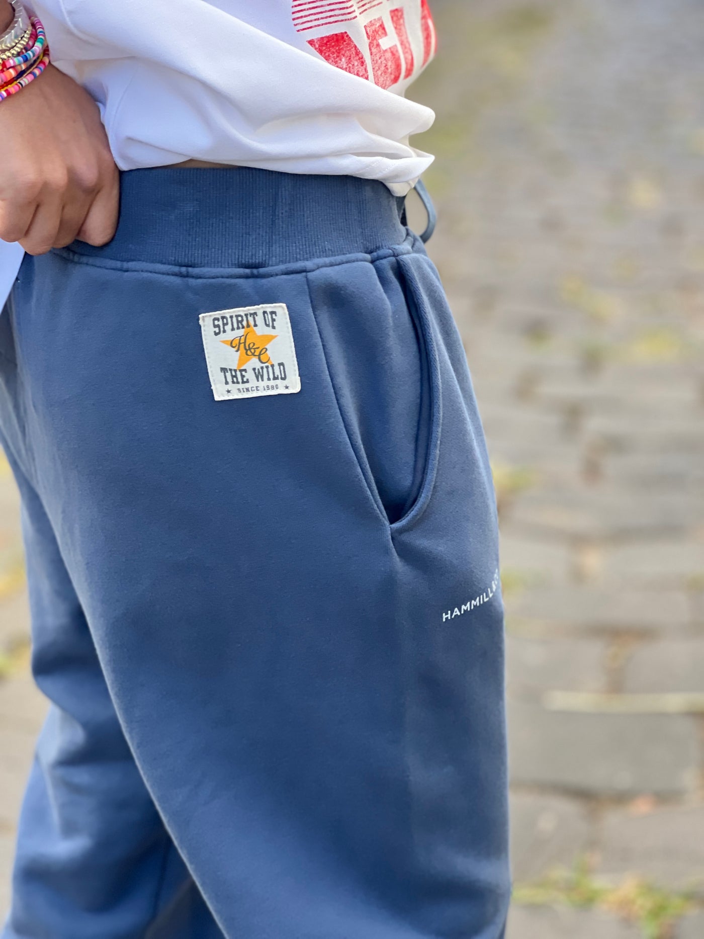 Hammill & Co Fleecy denim blue track pant with stripe cuffs, elastic waist band with draw cord, 7/8 length and small Hammill and Co logo on the right hip. Looks great worn back with the matching sweat.