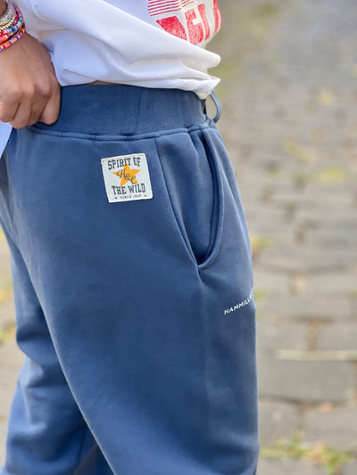 Hammill & Co Fleecy denim blue track pant with stripe cuffs, elastic waist band with draw cord, 7/8 length and small Hammill and Co logo on the right hip. Looks great worn back with the matching sweat.