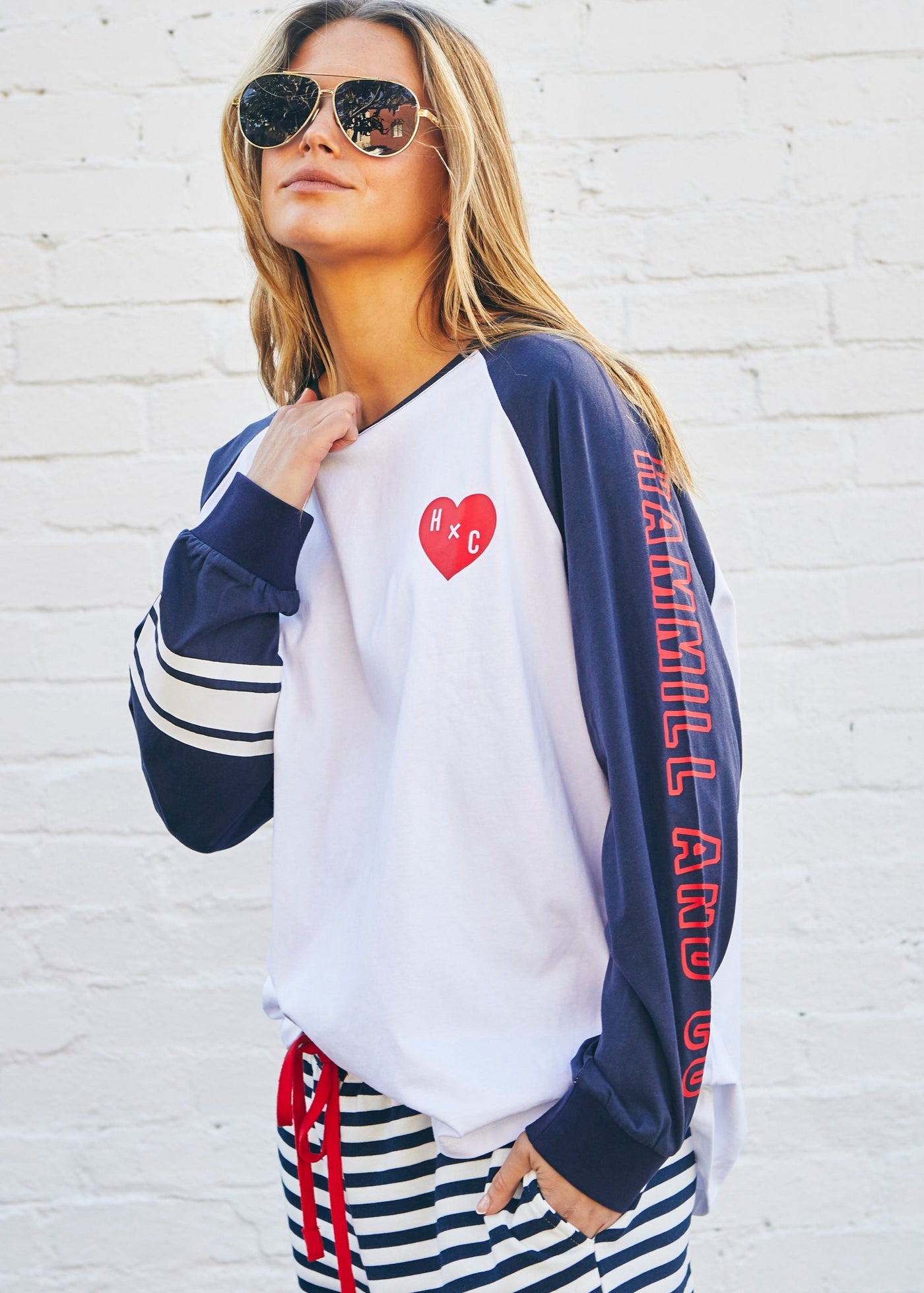 Hammill & Co Retro white long sleeve tee with contrast navy sleeves with pops of red print.