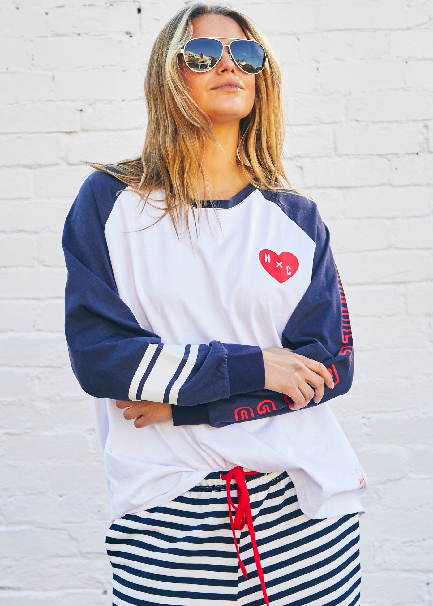 Hammill & Co Retro white long sleeve tee with contrast navy sleeves with pops of red print.