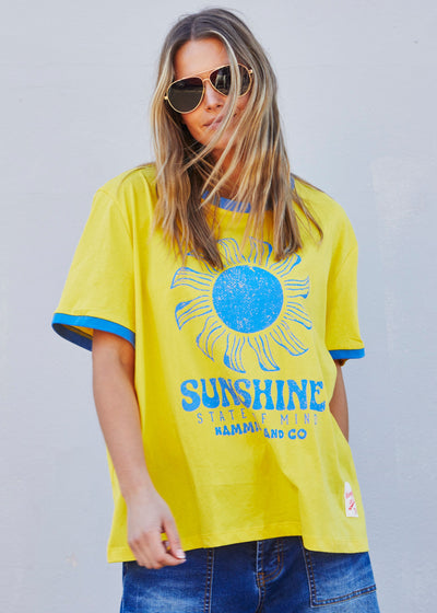 Hammill & Co Sunshine State of Mind tee in a slouchy V neck style in a soft bright yellow slub jersey with royal blue print on the front .