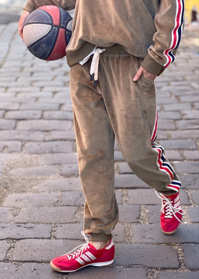 Hammill & Co Sporty velour track pants in soft khaki. Featuring stripe tape down each leg, natural draw cord with elastic waist and woven badge on the back pockets.