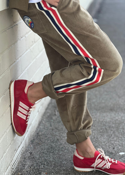 Hammill & Co Sporty velour track pants in soft khaki. Featuring stripe tape down each leg, natural draw cord with elastic waist and woven badge on the back pockets.