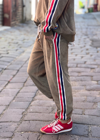 Hammill & Co Sporty velour track pants in soft khaki. Featuring stripe tape down each leg, natural draw cord with elastic waist and woven badge on the back pockets.