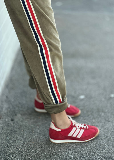 Hammill & Co Sporty velour track pants in soft khaki. Featuring stripe tape down each leg, natural draw cord with elastic waist and woven badge on the back pockets.