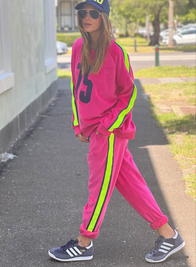 Hammill & Co  Sporty velour track pants in our best selling hot pink. Featuring stripe  none and navy tape down each leg, natural draw cord with elastic waist and woven badge on the back pockets.