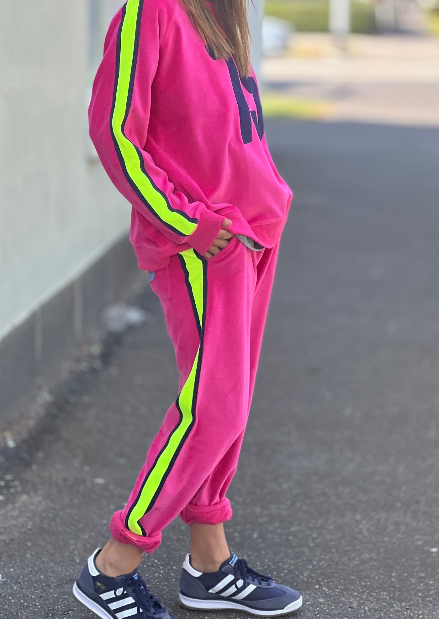 Hammill & Co  Sporty velour track pants in our best selling hot pink. Featuring stripe  none and navy tape down each leg, natural draw cord with elastic waist and woven badge on the back pockets.