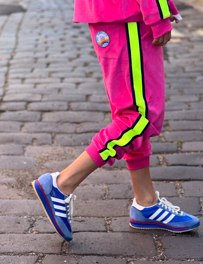 Hammill & Co  Sporty velour track pants in our best selling hot pink. Featuring stripe  none and navy tape down each leg, natural draw cord with elastic waist and woven badge on the back pockets.