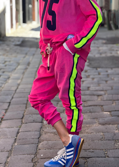 Hammill & Co  Sporty velour track pants in our best selling hot pink. Featuring stripe  none and navy tape down each leg, natural draw cord with elastic waist and woven badge on the back pockets.