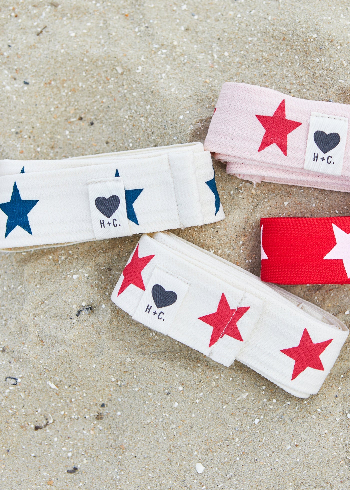 Hammill & Co Stretch natural tape with navy stars printed on one side and the other side plain. The end has small H+C badge.