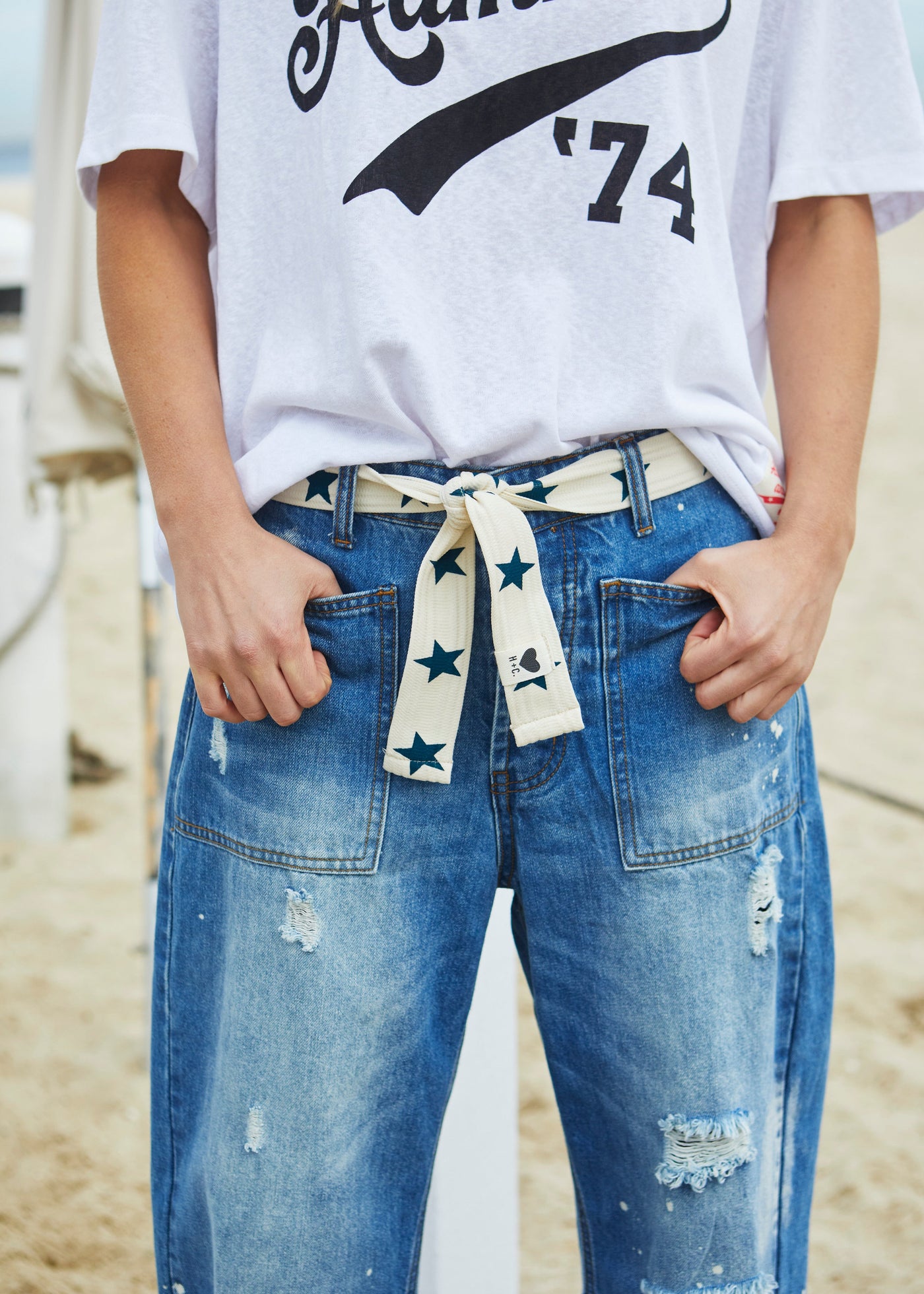 Hammill & Co Stretch natural tape with navy stars printed on one side and the other side plain. The end has small H+C badge.