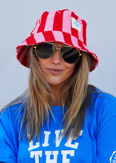 Hammill & Co bold striped bucket hat is pure summer happiness. Made from soft terry towelling in vibrant red and pink stripes
