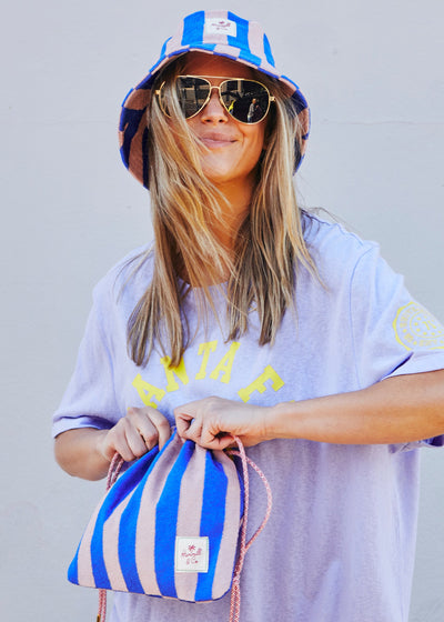 Hammill & Co bold striped bucket hat is pure summer happiness. Made from soft terry towelling in vibrant Royal and musk stripes.