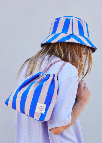 Hammill & Co bold striped bucket hat is pure summer happiness. Made from soft terry towelling in vibrant Royal and musk stripes.
