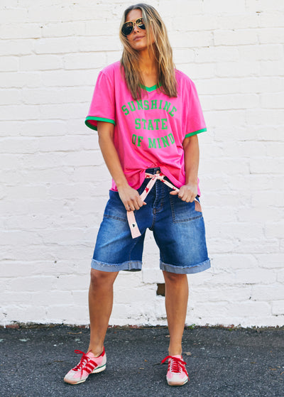 Hammill & Co Slouchy V neck tee in a soft hot pink slub jersey with green print on the front . Contrast green rib&nbsp; Looks great worn back with our denim shorts or jeans!
