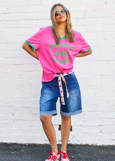 Hammill & Co Slouchy V neck tee in a soft hot pink slub jersey with green print on the front . Contrast green rib&nbsp; Looks great worn back with our denim shorts or jeans!