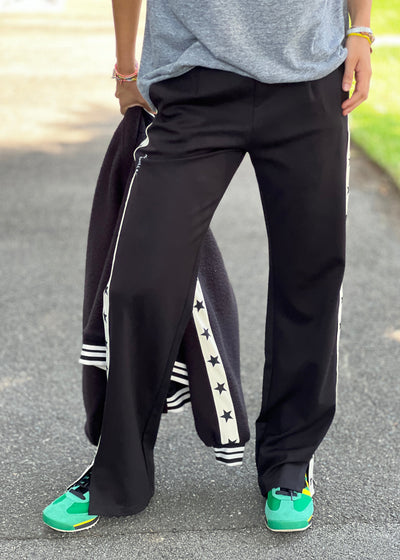 Hammill & Co wider leg street pant is a new addition to our track pant offering, an easy pull versatile style that is super comfy yet super stylish which can be dressed up or down!
Relaxed Varsity wider leg casual track pant with contrast tape down both legs with stars.