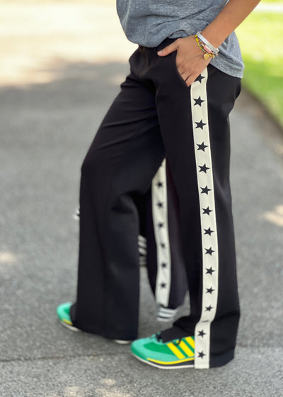 Hammill & Co wider leg street pant is a new addition to our track pant offering, an easy pull versatile style that is super comfy yet super stylish which can be dressed up or down!
Relaxed Varsity wider leg casual track pant with contrast tape down both legs with stars.