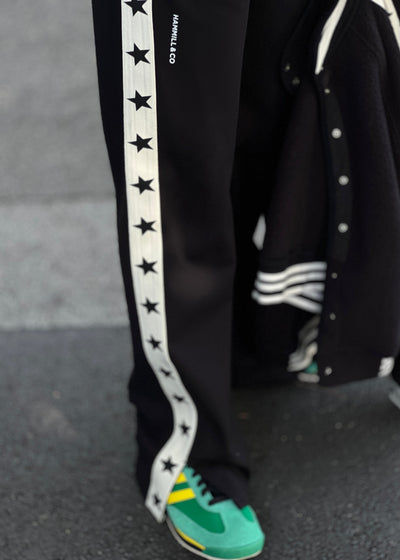 Hammill & Co wider leg street pant is a new addition to our track pant offering, an easy pull versatile style that is super comfy yet super stylish which can be dressed up or down!
Relaxed Varsity wider leg casual track pant with contrast tape down both legs with stars.