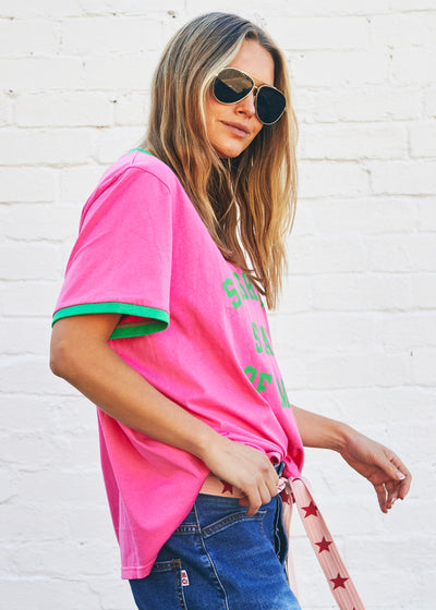 Hammill & Co Slouchy V neck tee in a soft hot pink slub jersey with green print on the front . Contrast green rib&nbsp; Looks great worn back with our denim shorts or jeans!